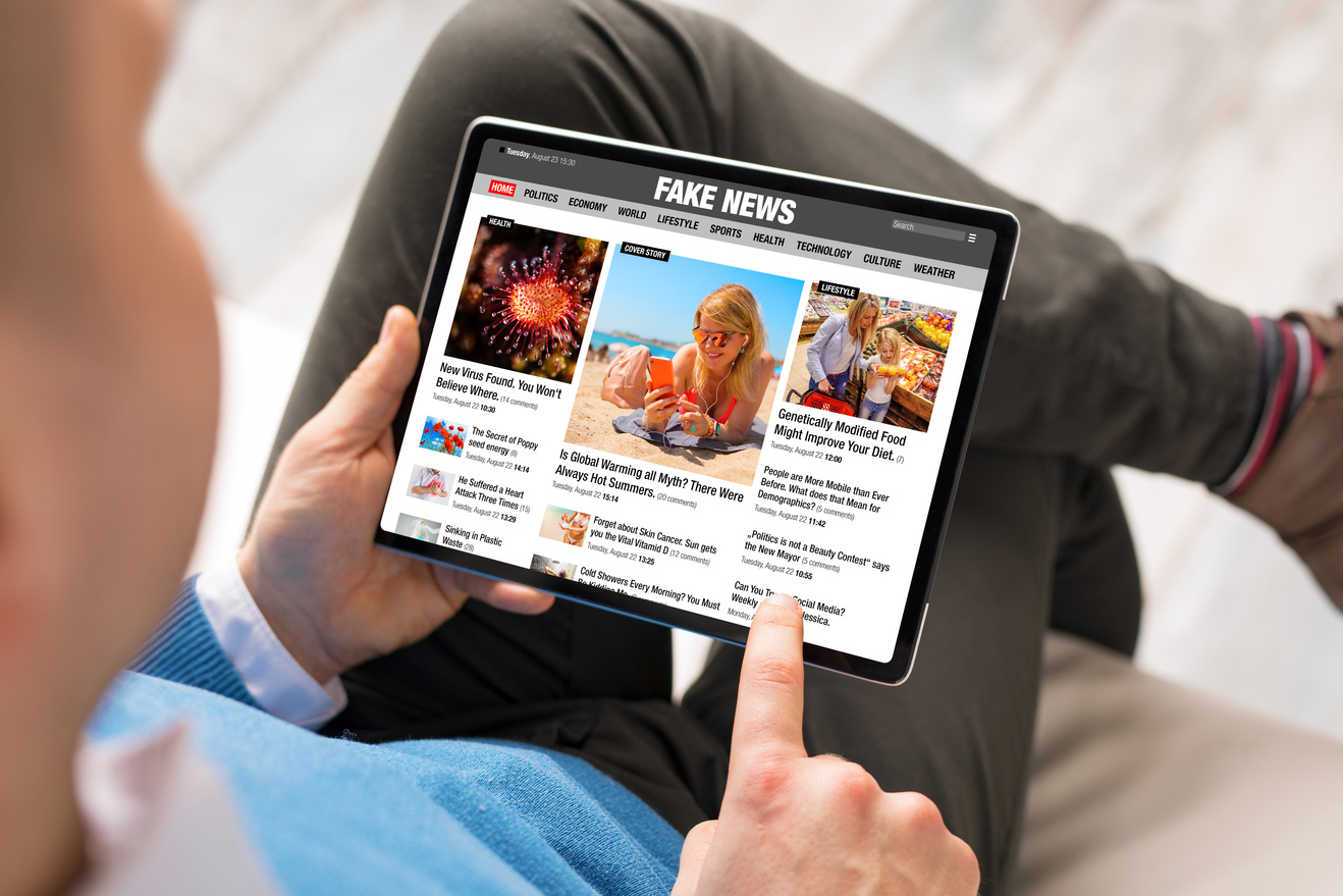 Concept of fake news being published online on news websites and social media
